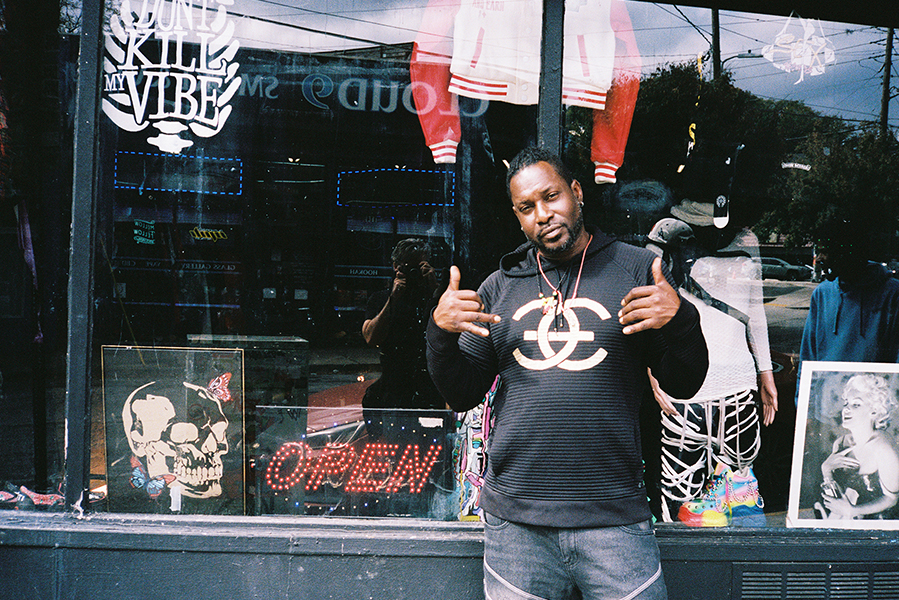 A man posing outside a Little Five Points storefront